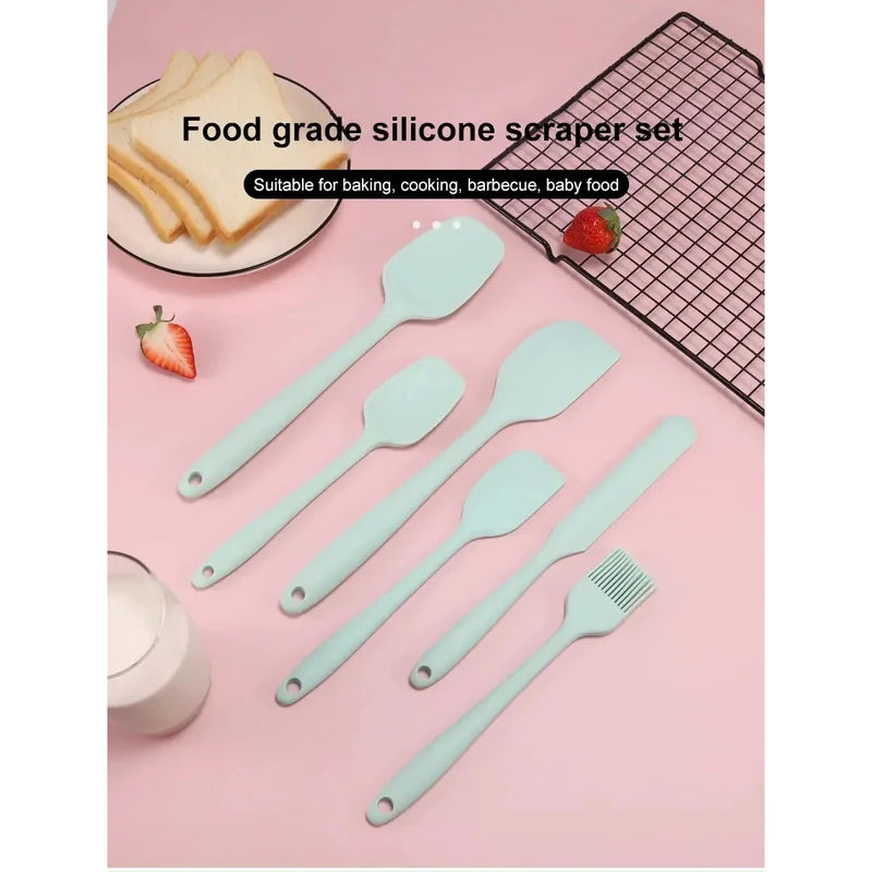 Set of food-grade silicone spatulas on a pink background with baking items.