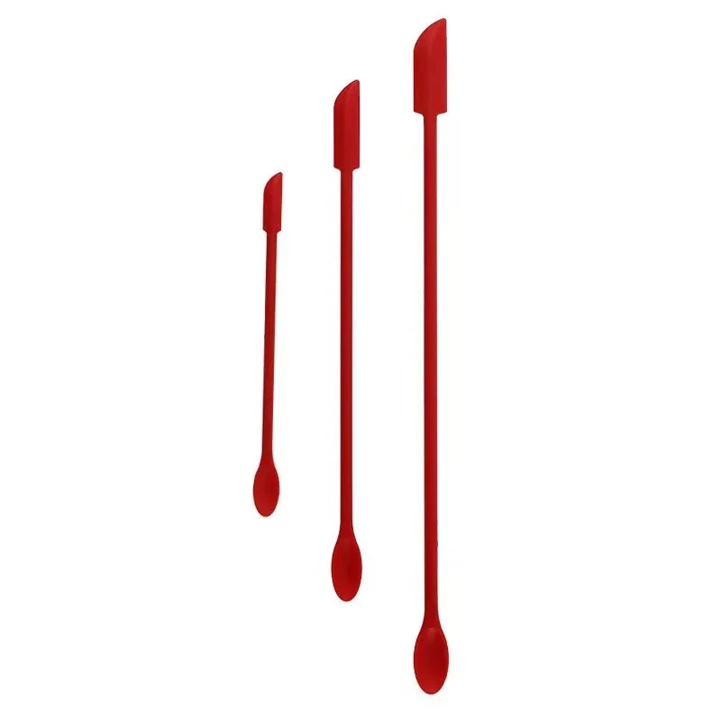 Three red spatulas of varying sizes on a white background